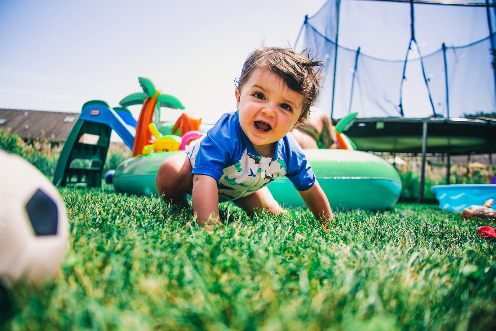 The 12 Best Toddler Trampoline Models in 2022 Toddler Trampoline boy in blue and white crew neck t-shirt sitting on green grass field during daytime